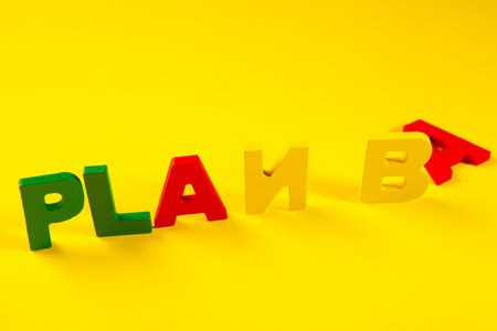 Plastic letters spelling the word Plan B on a yellow background.