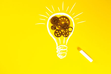 Light bulb with gears and cogs on yellow background. Business idea concept