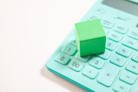 House model and calculator on white background. Business and finance concept.