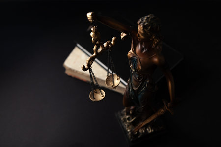 Law theme, mallet of judge, wooden gavel on black background