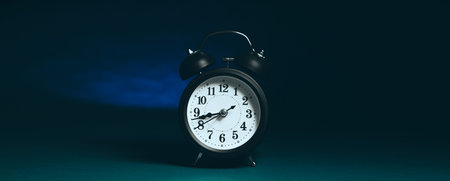 Retro alarm clock on a dark blue background. 3d rendering