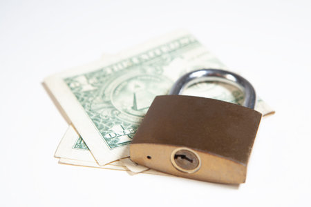 Padlock and dollars on a white background. Money security concept.
