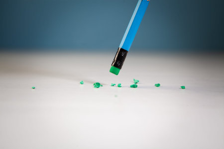 Pencil eraser with eraser on a white table with blue background