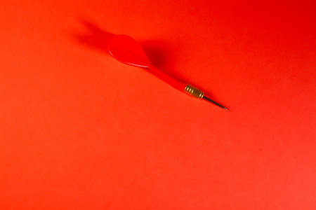 Red dart on a red background. The concept of business success.