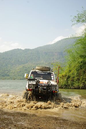 KANCHANABURI THAILAND - MAY 15 : Unidentified man drive Suzuki Caribien to testing ability of modified equipment and suspention for use on the barrens route on May 15,2006 at Srinakarin reservoir, Ban Krai Kriang, Kanchanaburi, Thailand.のeditorial素材