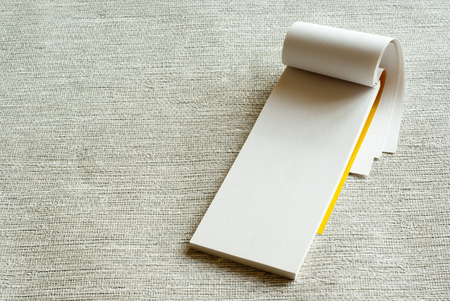 Writing pad on grey backgroundの写真素材