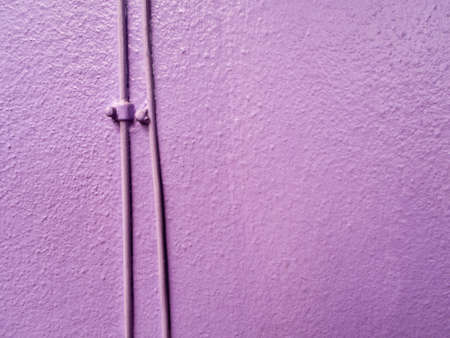 Telephone wiring on the wall are painted purpleの写真素材