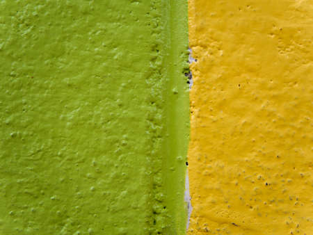 Background and Texture from high detail painted concrete wall / Yellow & Green colored backgroundの写真素材