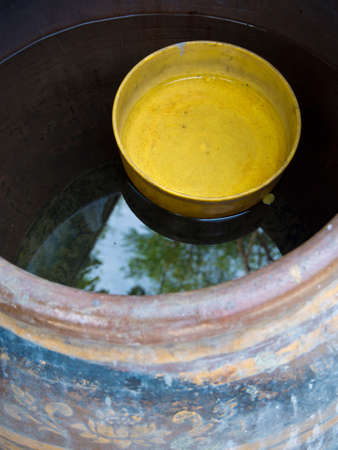 Yellow plastic bowl float in the Jarの写真素材