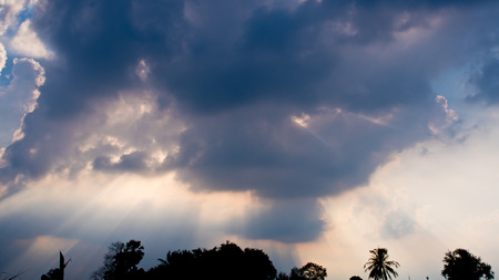 Beam of Sunlight behind dark clouds in the countryside