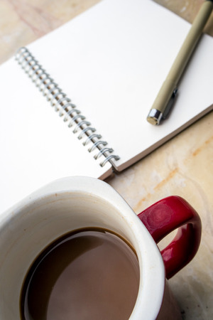The blank page of a spiral notebook and coffee cupの写真素材