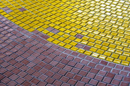 Yellow, White and Brown tiles on the floor of hallの写真素材