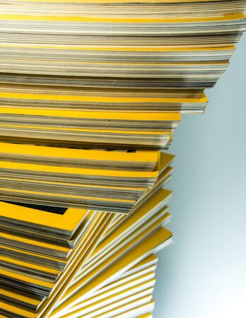 Stack of yellow color monthly magazineの写真素材
