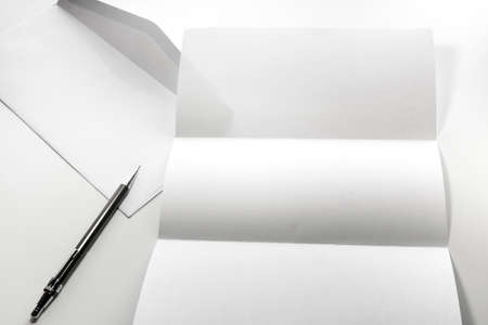 blank of letter paper and white envelope with pen Isolated on white backgroundの写真素材