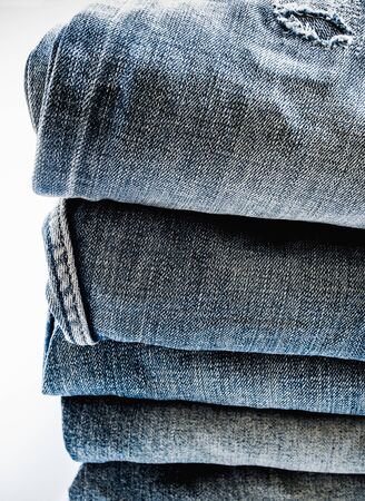 Pile of different blue jeans, fabric textureの写真素材