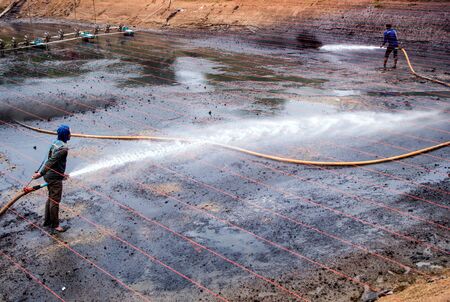 CHACHOENGSAO THAILAND - JULY 13 : Unidentified men control high pressure water jet nozzle to clean...