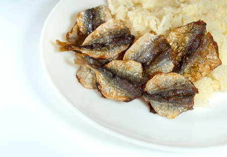 Close up isolated sticky rice and fried sun-dried fish, take home street foodの写真素材