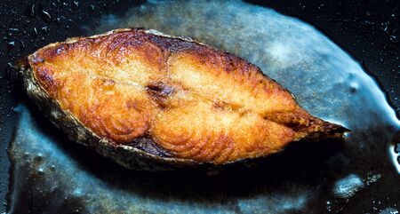 Mackerel pieces fried in a pan, food cookingの写真素材