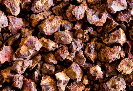 Red color of Iron oxide on gravel surface of broken laterite stoneの写真素材
