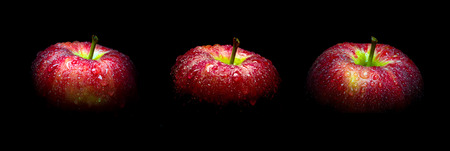 Close-up of Water droplet on glossy surface of freshness red apple on black background