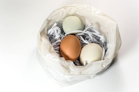 Eggs on the straw paper in recycle plastic bag, raw food packageの写真素材