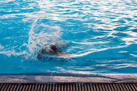Swimmer and the ripple on water surface in the swimming poolの写真素材