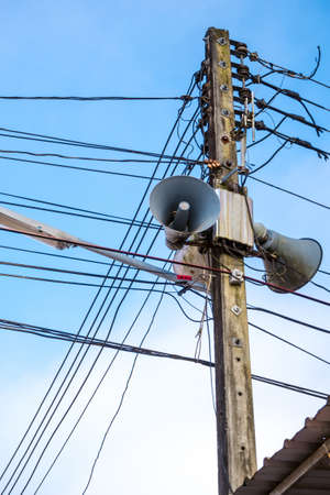Streetlamp and loudspeaker with accessories of electricity equipment on electric pole on sky backgroundの写真素材