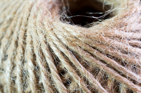 Texture of the brown natural rustic hemp cord in roll, close up