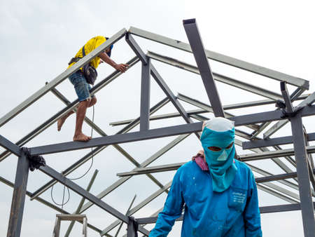 Workers working in the construction site to build a houseの写真素材