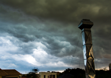 Dark cloud and sky before storm come with factory chimneyの写真素材