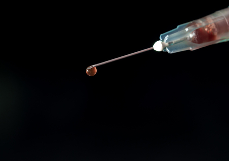 Syringe, injection needle on black backgroundの写真素材