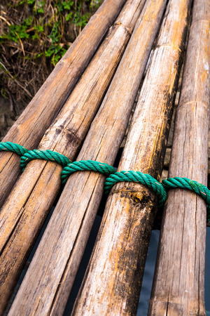 Dried bamboo tie with green nylon rope as a small bridgeの写真素材
