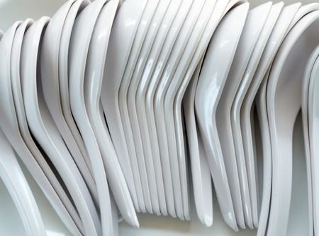 Lots of white porcelain plastic soup spoonsの写真素材