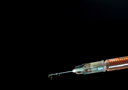 Syringe, injection needle on black backgroundの写真素材