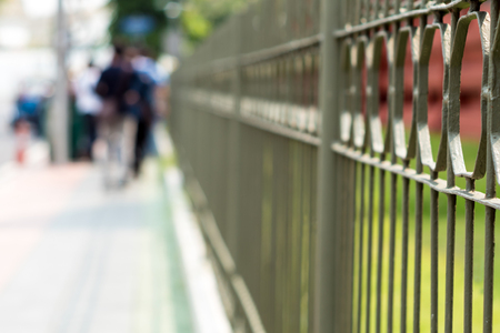Wrought iron fence beside a street in the cityの写真素材