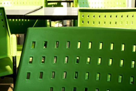 Empty white tables and green color plastic chairs that nobody sit in the cafeteriaの写真素材