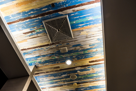 Air conditioner mask, lighting and modern equipment On the ceiling that decorated with old wooden...