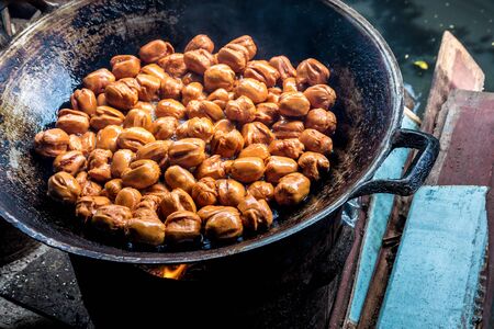 Frying meatballs in old frying pan on firewood stovesの写真素材