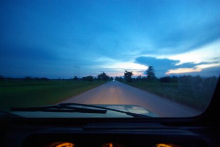 Looking straight on the road from the car that was running on the route back homeの写真素材