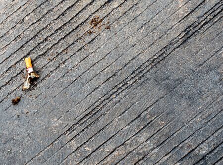 The cigarette butt let down on the concrete floor