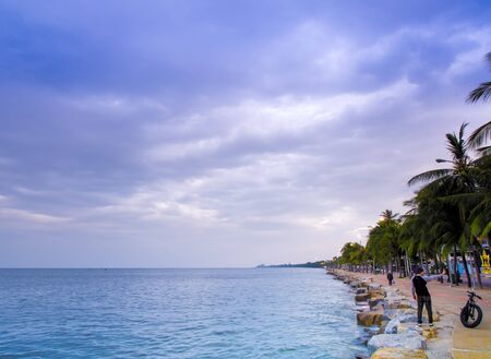 The sea is calm and the skyâs overcast with rain clouds in the morning of the coastal areaの写真素材