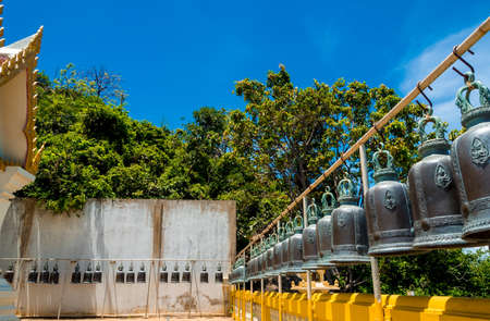 Hanging brass bells arranged on the temple terraceの写真素材