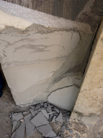 Concrete fragments and foam sheets from broken, damaged wallsの写真素材