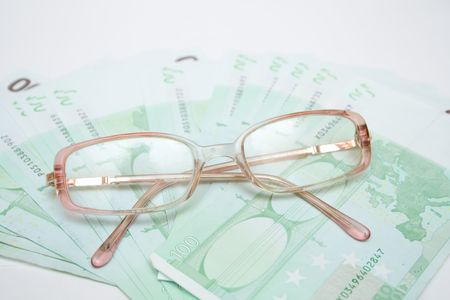 modern eyeglasses over money euroの写真素材
