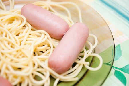 spaghetti and sausage on the plateの写真素材