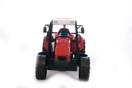 Tractor red toy on white