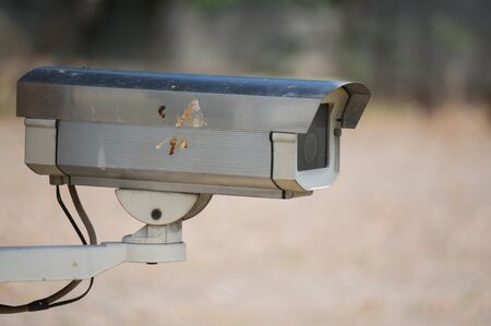 old fashion cctv security camera in the sunny field.