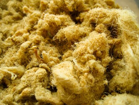 close-up of shredded dried pork look like fur or mountain of brown furの写真素材
