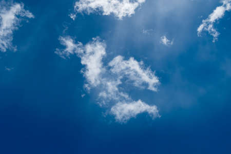floating white cloud in bright blue sky in sunny dayの写真素材