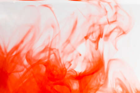 out of focus red ink drop in crystal clear water, soft focus of red ink in clear water,の写真素材